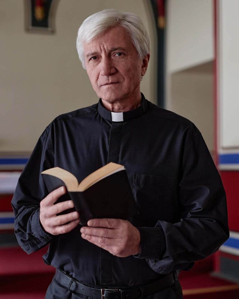 senior-priest-with-bible-in-church-BHVBH9B (1)